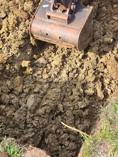Excavator working on residential basement excavation in Norman OK