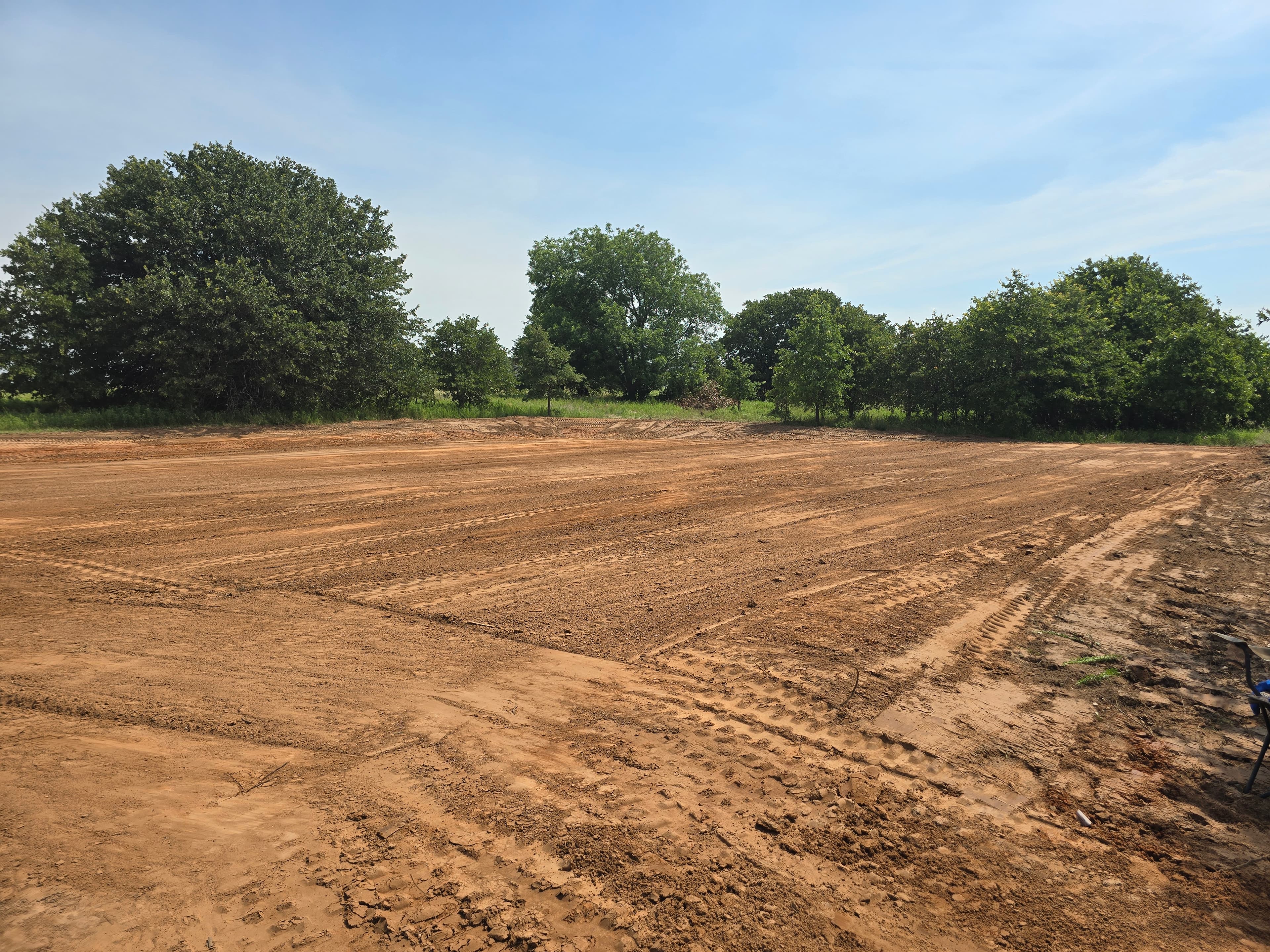 Freshly graded dirt work area prepared for site and driveway development